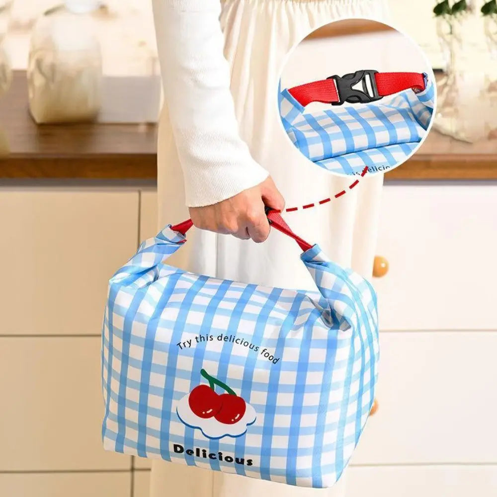 Blue checkered kawaii bag with cherry design held by a person in a kitchen setting