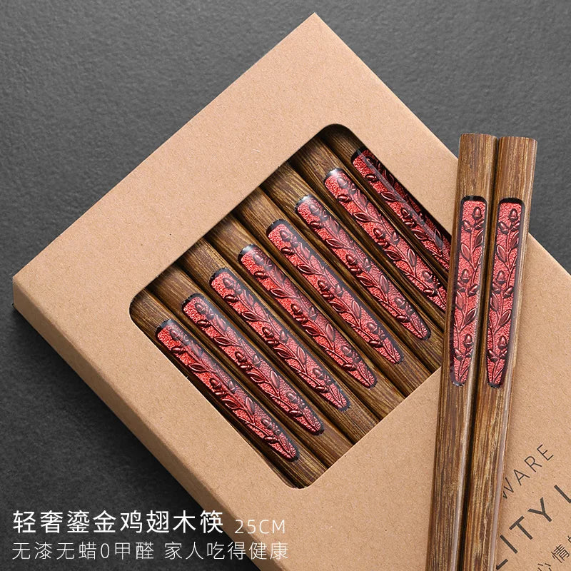 Wooden kawaii chopsticks with red patterns in a brown box on a dark background