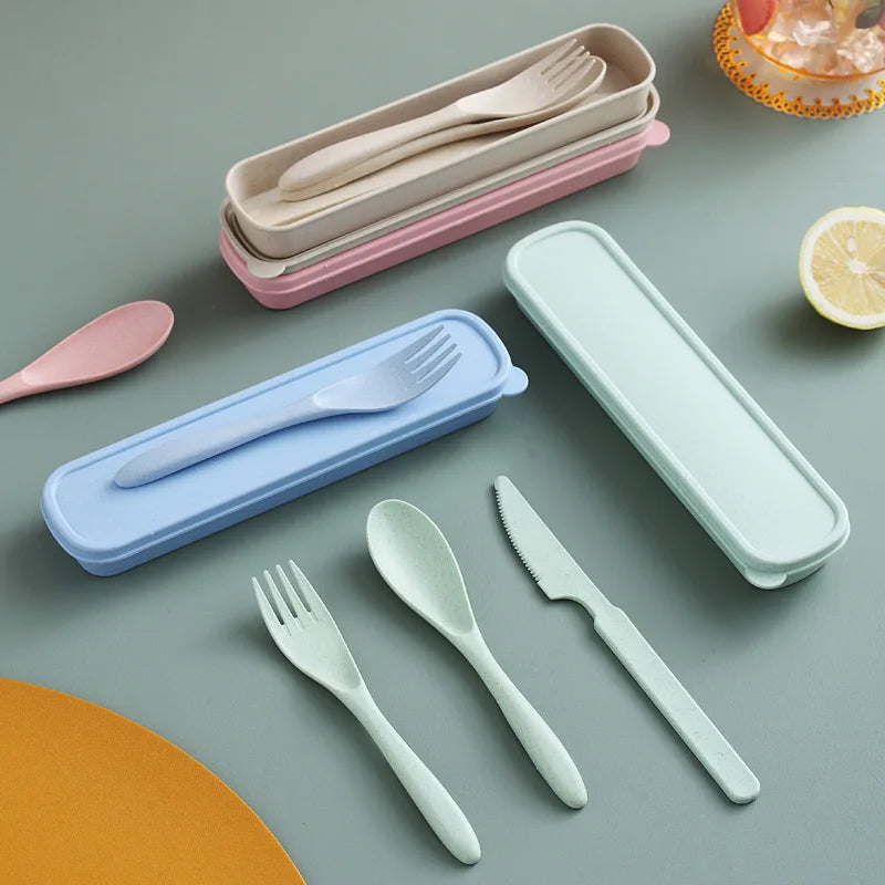 Set of portable kawaii utensils with colorful cases on a gray surface