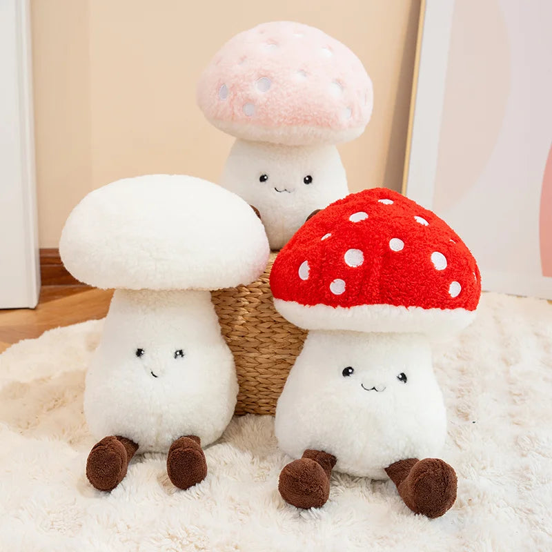 Three kawaii plush mushroom toys on a soft surface with a neutral background