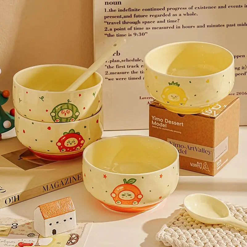 Four kawaii bowls in various colors on a table