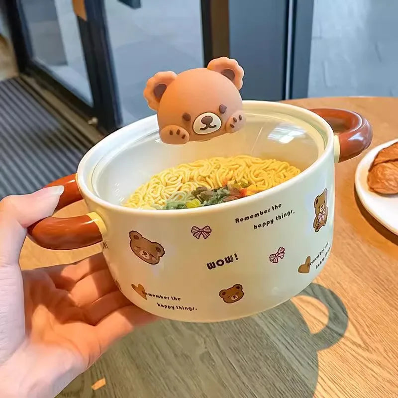 A hand holding a bear themed kawaii ramen bowl