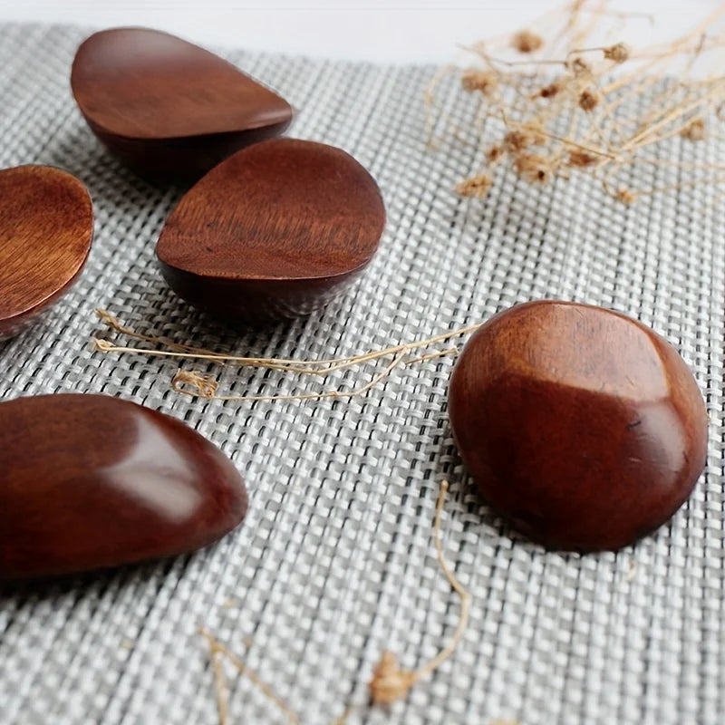Wooden kawaii chopstick holders on a textured fabric background