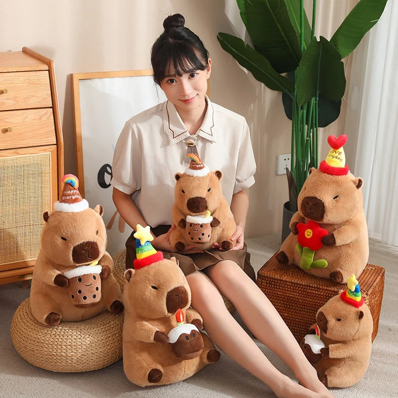 Person sitting on a chair with five brown capybara plush toys resembling beavers with colorful hats.