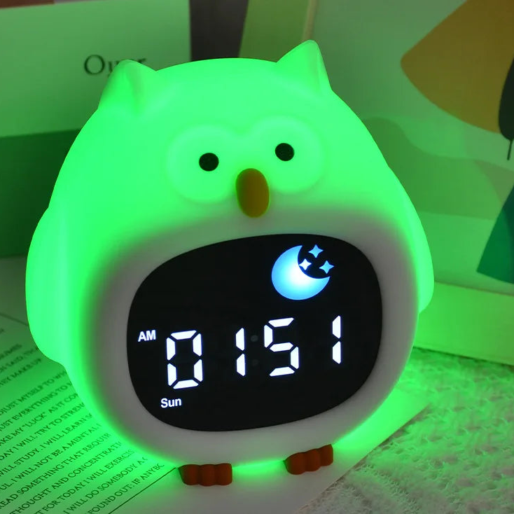 Green owl-shaped digital clock with glowing green body on a light background