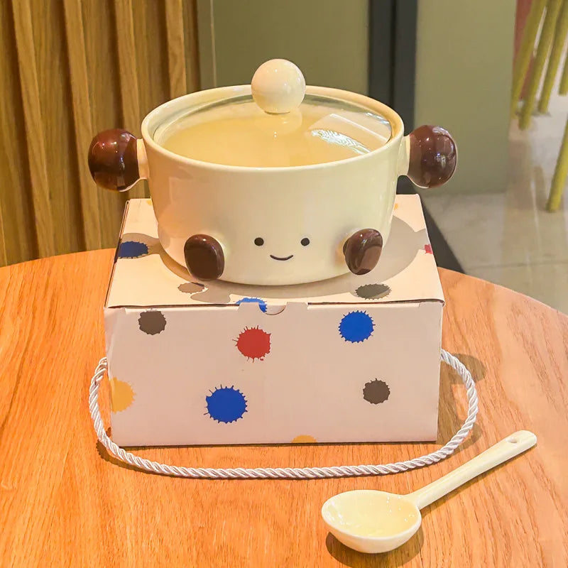 Cute ceramic kawaii bowl with a lid on a box with polka dots, on a wooden table.