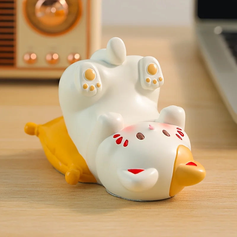 Cute kawaii cartoon-like cat figurine on a wooden surface with a blurred background