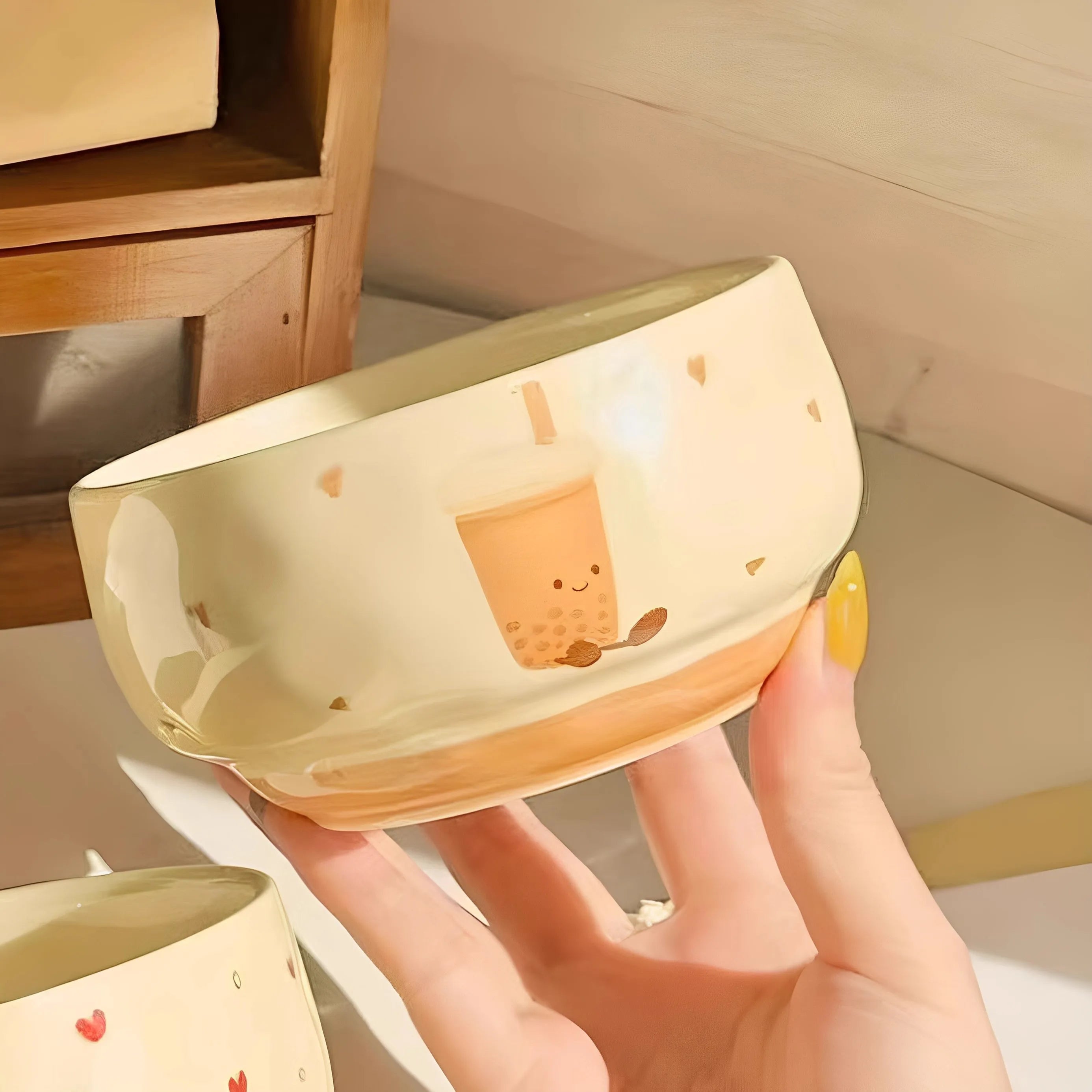 A boba tea designed kawaii bowl being held by someone