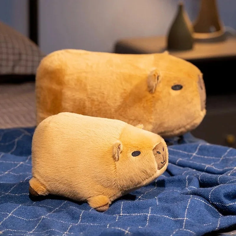 Two kawaii plush guinea pigs on a blue checkered blanket