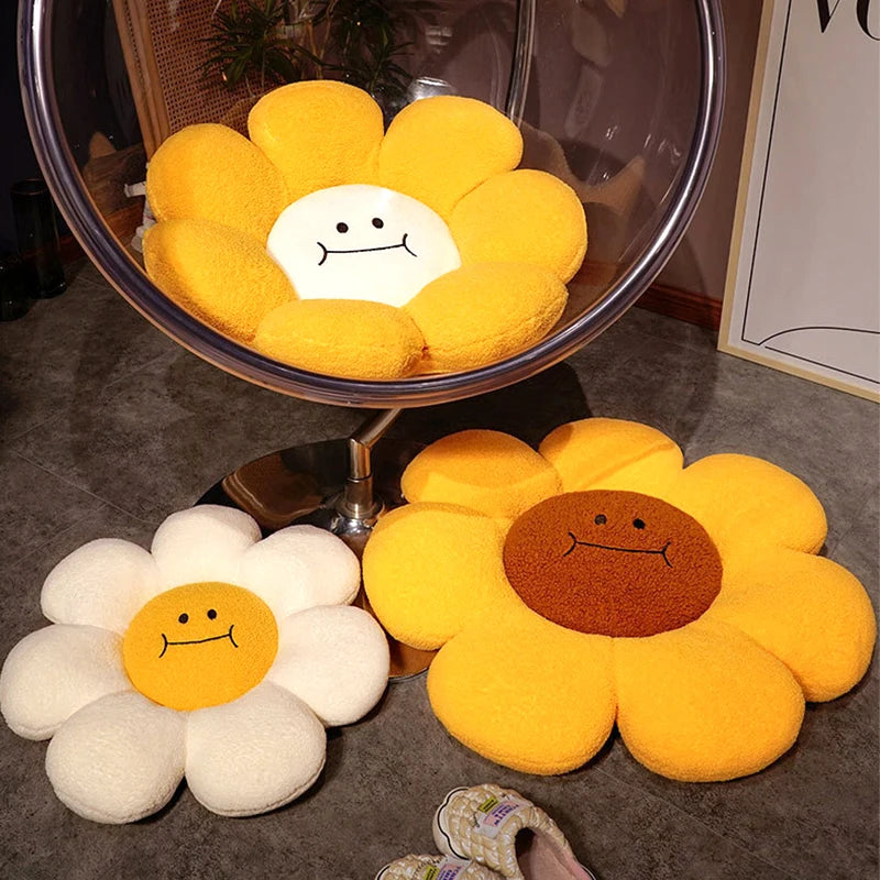 Sunflower-shaped kawaii cushions in various colors on a floor with a chair in the background.
