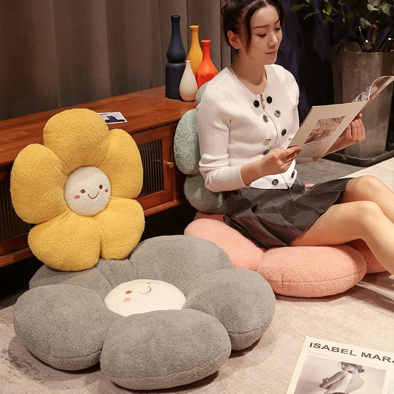 Woman reading a magazine with flower-shaped kawaii cushions on a wooden floor.
