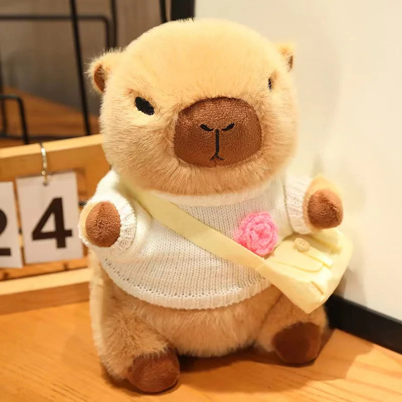 Kawaii plush bear toy wearing a white sweater with a pink flower, standing on a wooden floor.