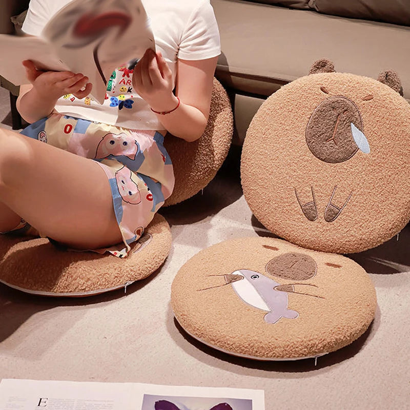 Round brown kawaii cushions with animal designs on a floor, with a child in a cartoon-themed outfit.