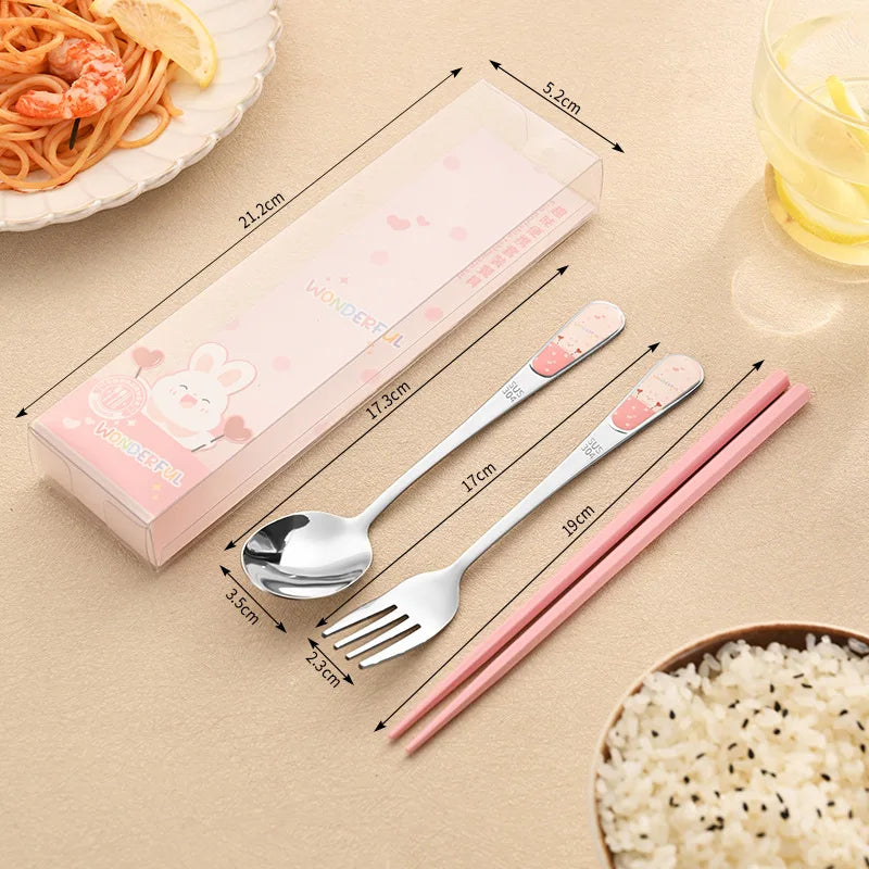 Set of kawaii utensils including spoon, fork, and pink chopsticks with measurements on a beige surface.