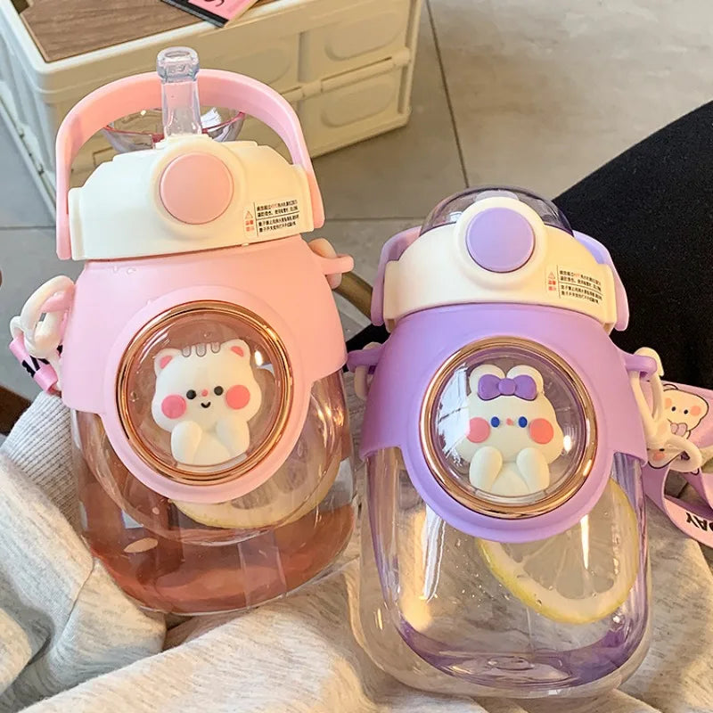 Two cartoon-themed kawaii water bottles with animal designs on a light surface.