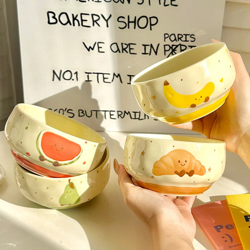 A group of cartoon designed kawaii bowls being held by a person