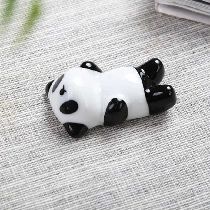 Panda-shaped kawaii chopstick holders on a textured surface with dimensions displayed.