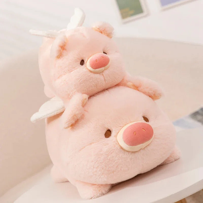 Two pink kawaii plush toys shaped like pigs stacked on top of each other.