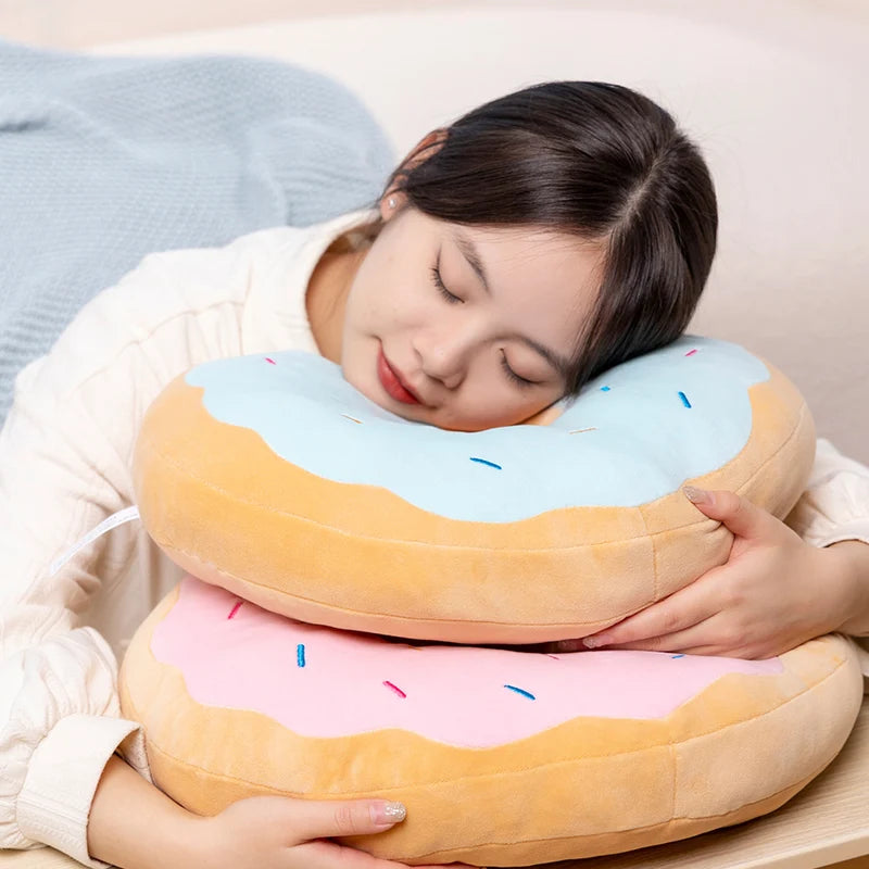 Person holding a donut-shaped kawaii pillow with sprinkles