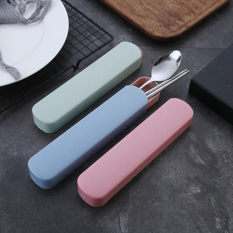 Set of three colorful carrying cases for kawaii utensils on a dark surface.