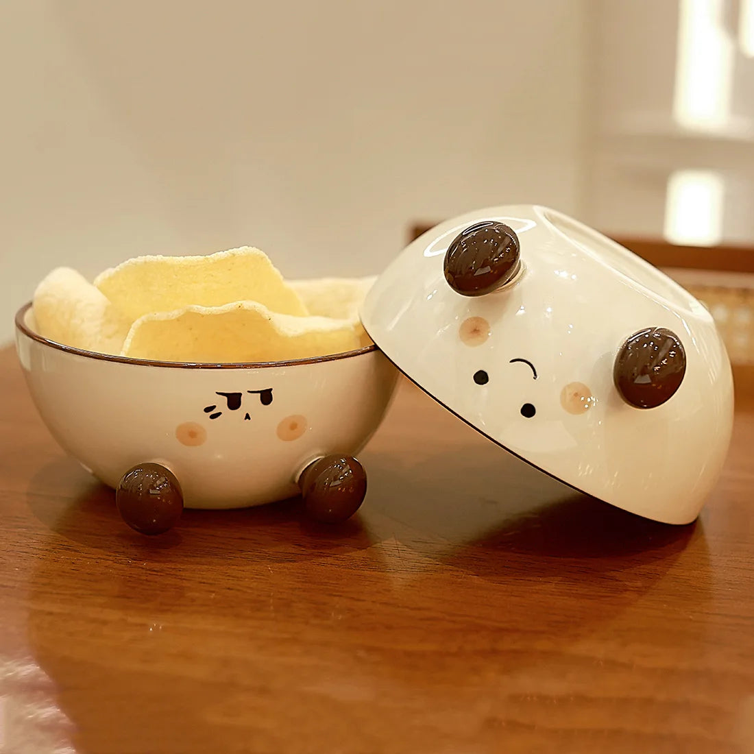 Cute ceramic kawaii ramen bowl and lid with cartoon face design on a wooden surface
