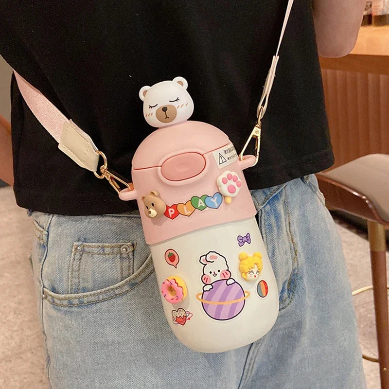 Person wearing a cute pink and white kawaii water bottle with cartoon characters and a bear on top.