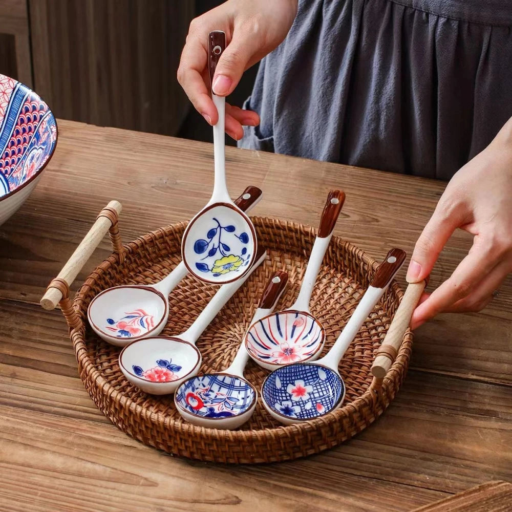 A person holding a ceramic kawaii spoon with others on a tray