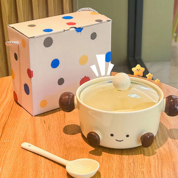 Ceramic kawaii bowl with lid, spoon, and polka dot gift box on a wooden surface
