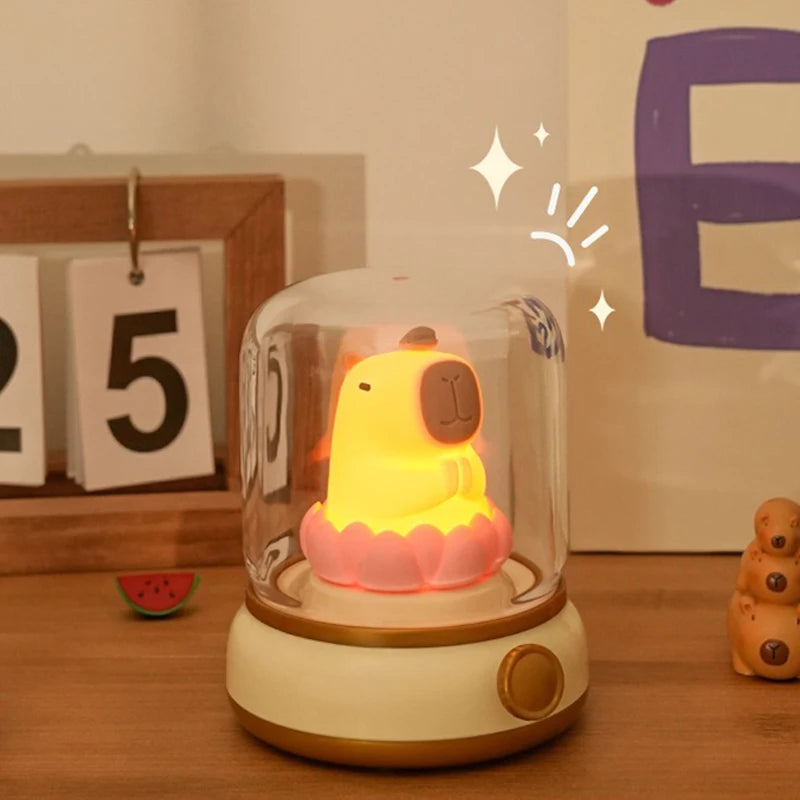 Decorative night light with a kawaii cartoon character inside a glass dome on a wooden surface.