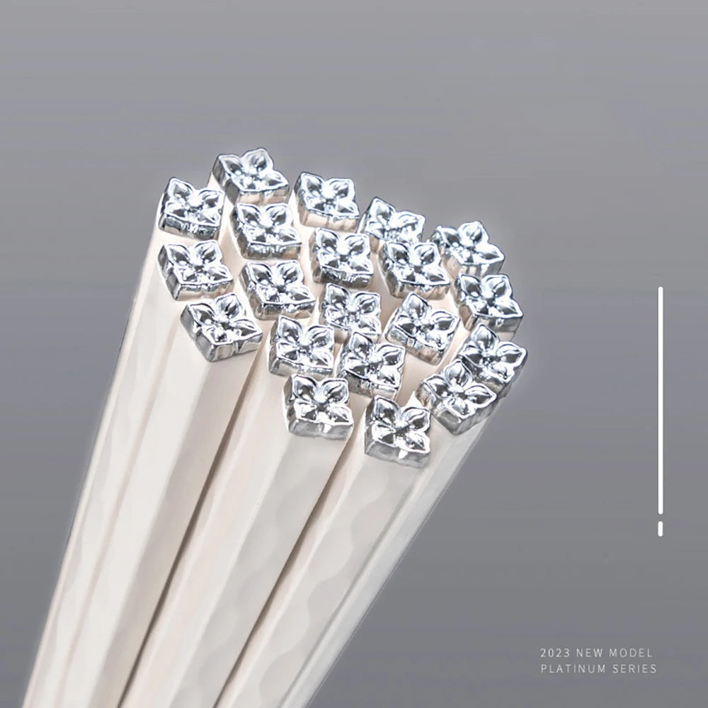 Silver kawaii chopsticks on a gray background