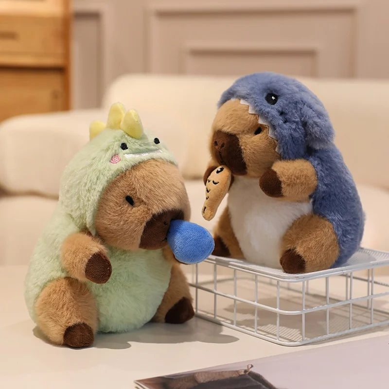Two kawaii plush toys resembling a dinosaur and a penguin sitting on a surface with a blurred background.