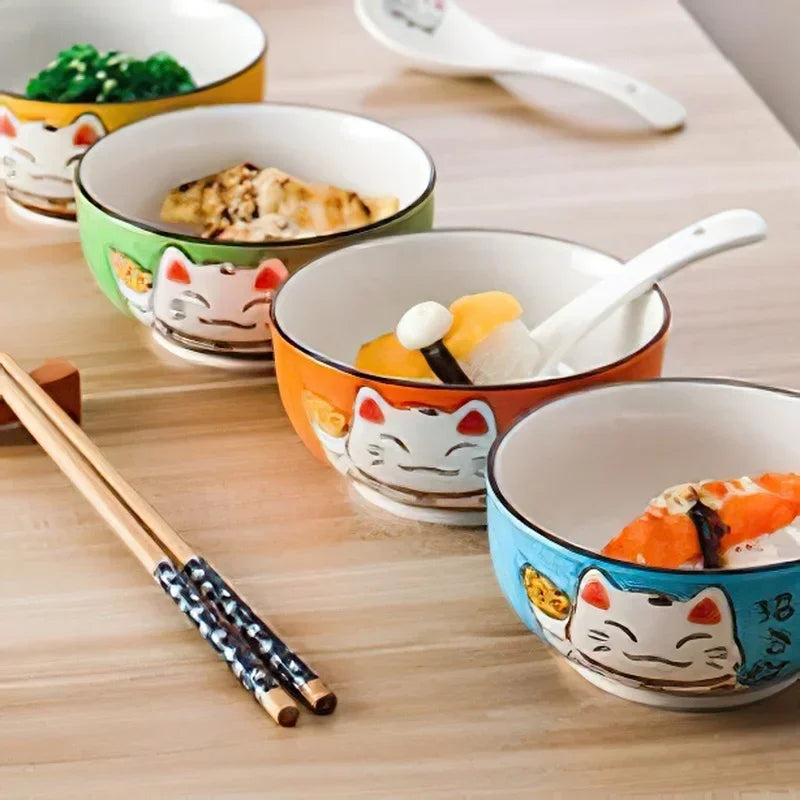 Set of colorful kawaii bowls with cat designs on a wooden table.