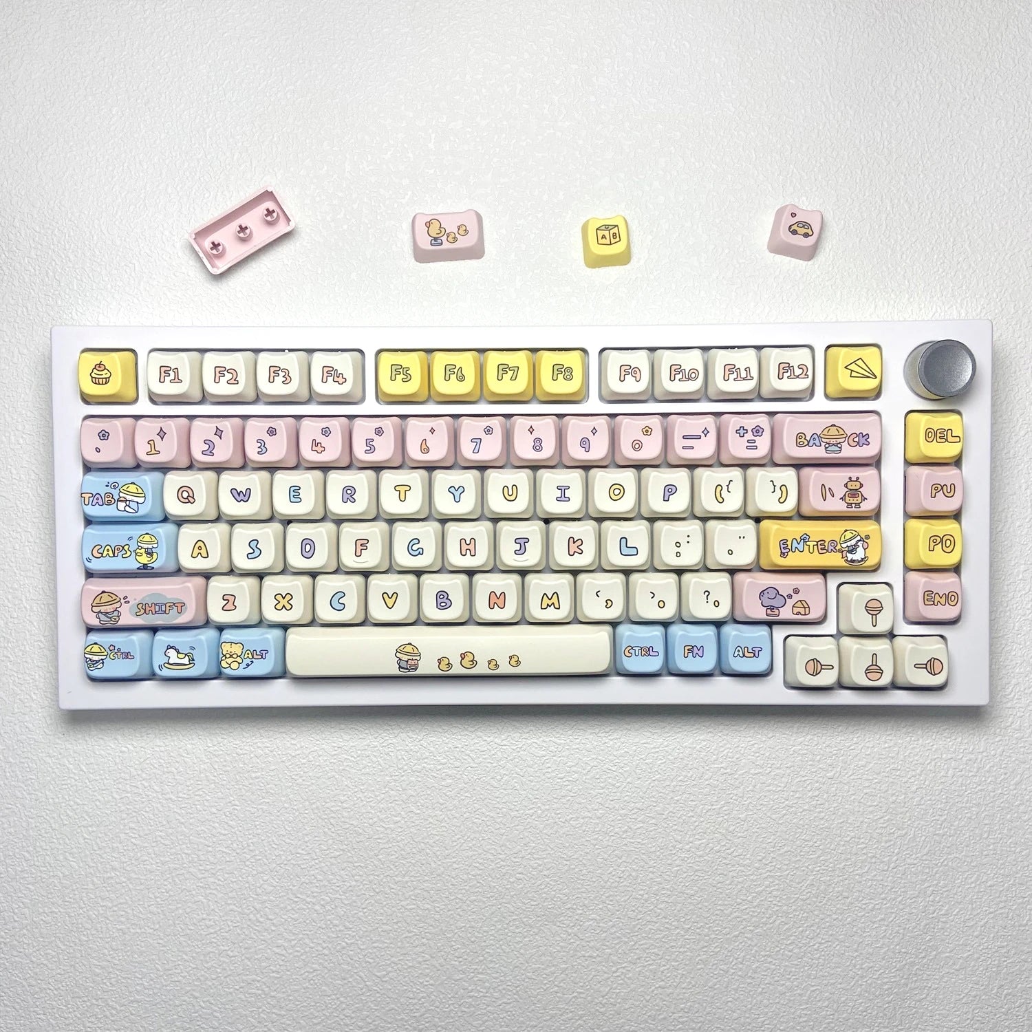 Keyboard with Kawaii colorful keycaps on a light gray background