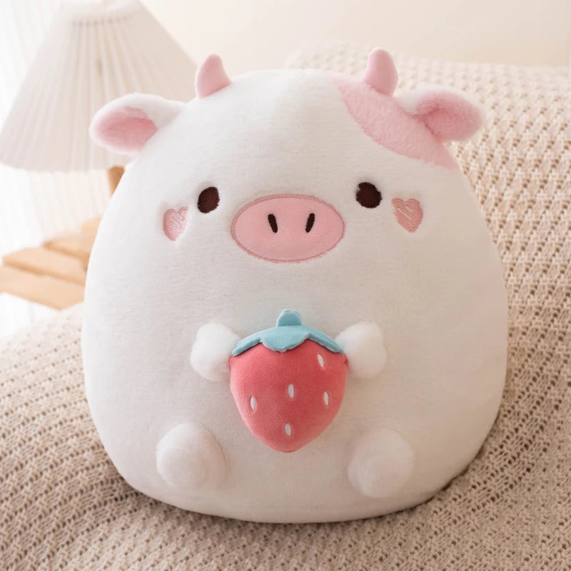Cute kawaii plush toy shaped like a pig with a strawberry on a soft surface