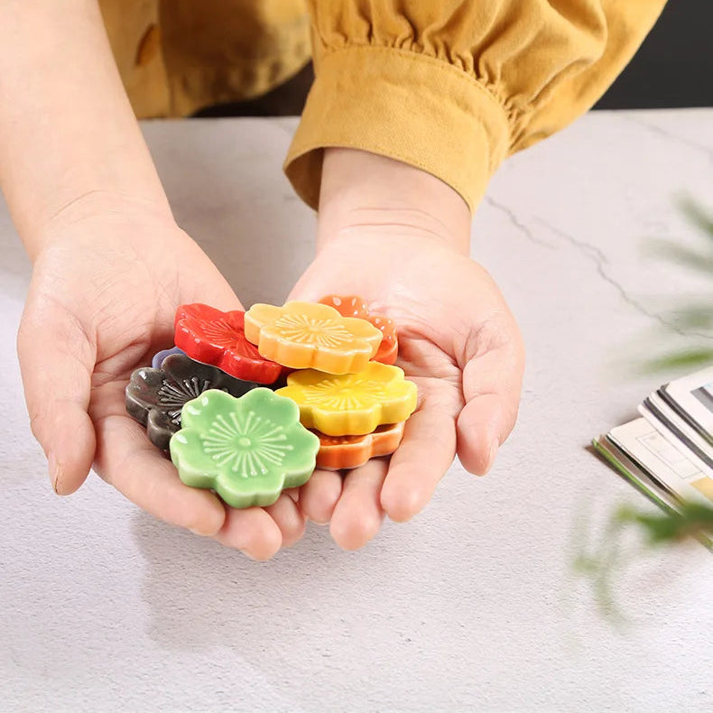 A woman holding a number of kawaii chopstick holders