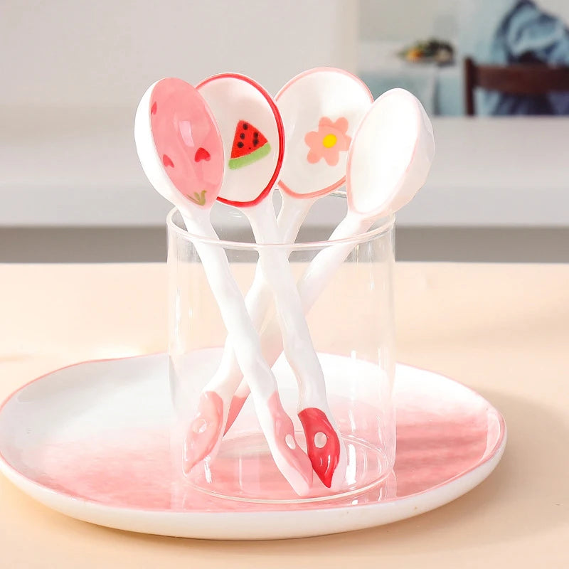 Four white and pink kawaii spoons inside a glass