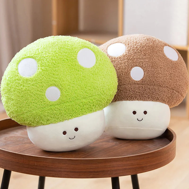 Two kawaii plush mushroom toys on a wooden table with a neutral background