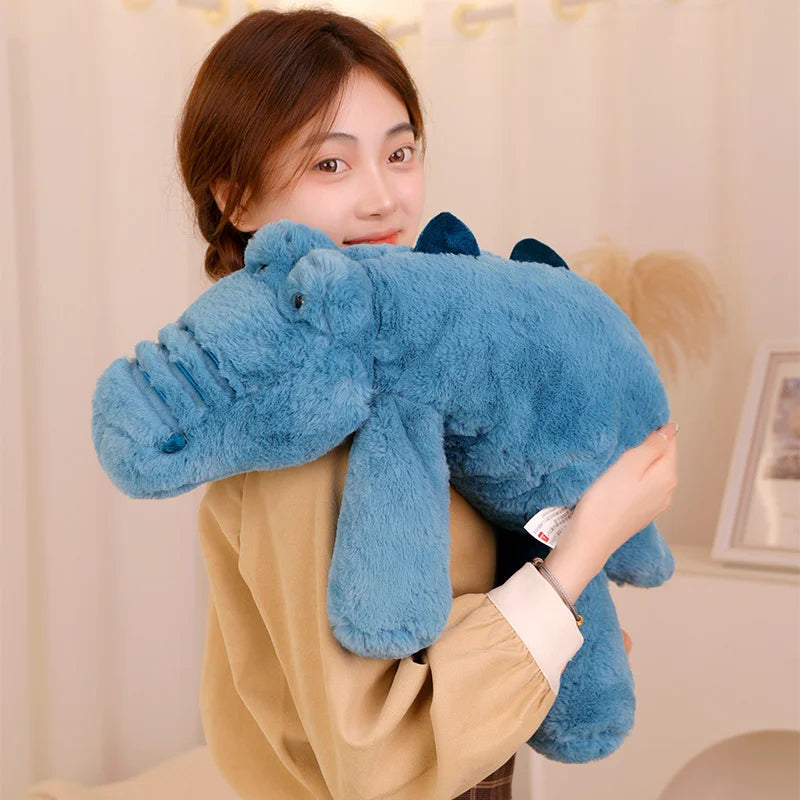 Person holding a blue kawaii plush toy in a room with a neutral background