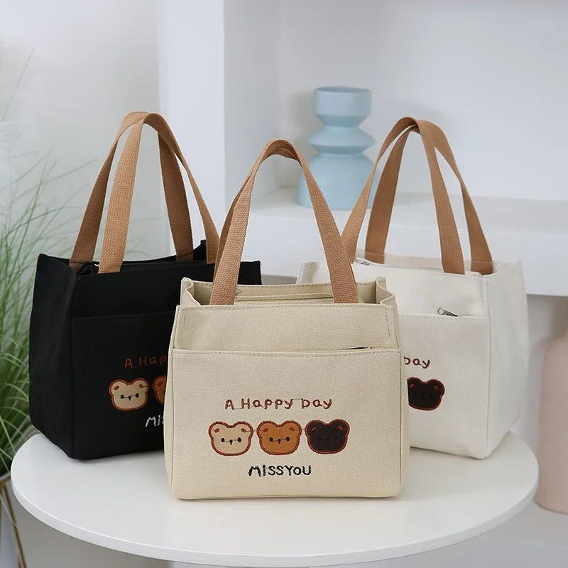 Three kawaii tote bags with bear designs and text on a white surface.
