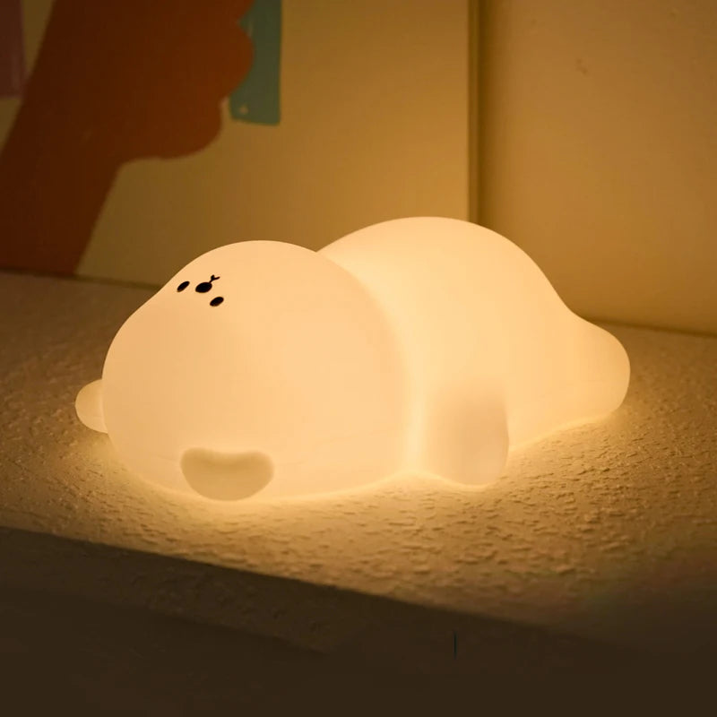Cute animal-shaped kawaii night light on a textured surface with warm glow