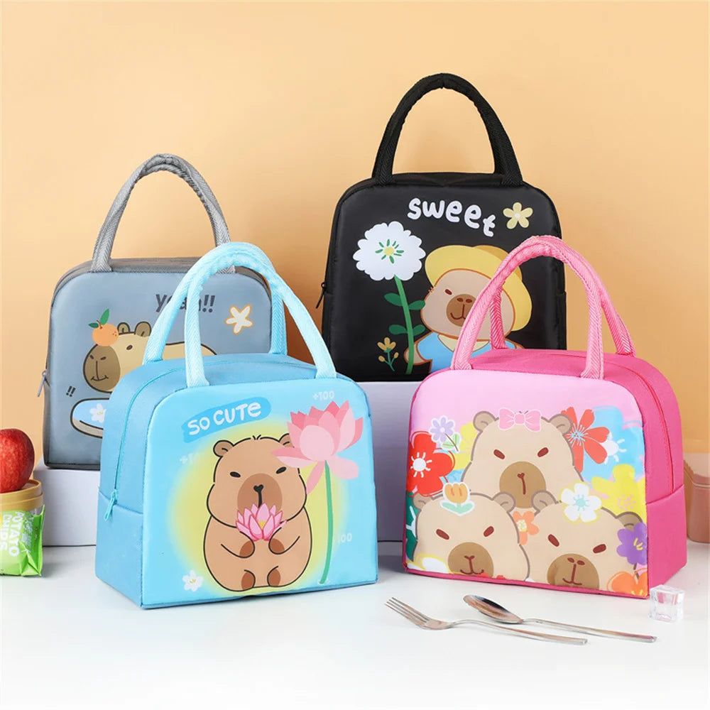 Four colorful kawaii lunch bags with cartoon designs on a white surface against a beige background.
