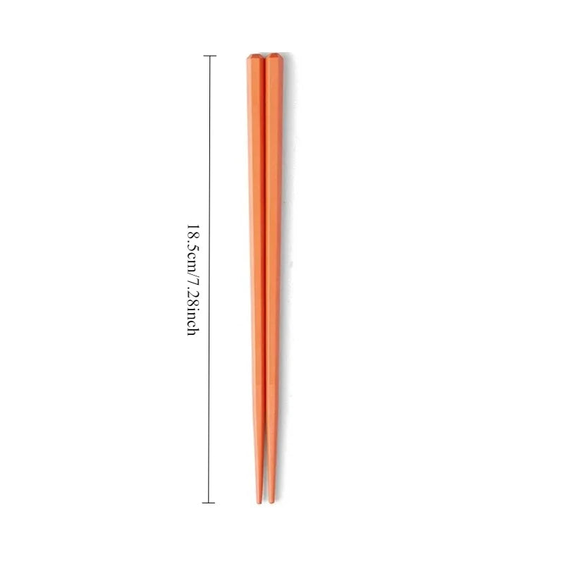 Pair of rose gold kawaii chopsticks with measurement text on a white background