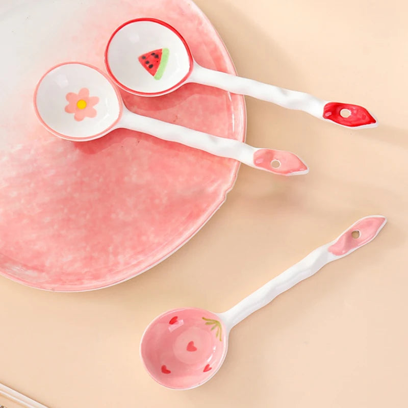 Three white and pink kawaii spoons on a dinner plate