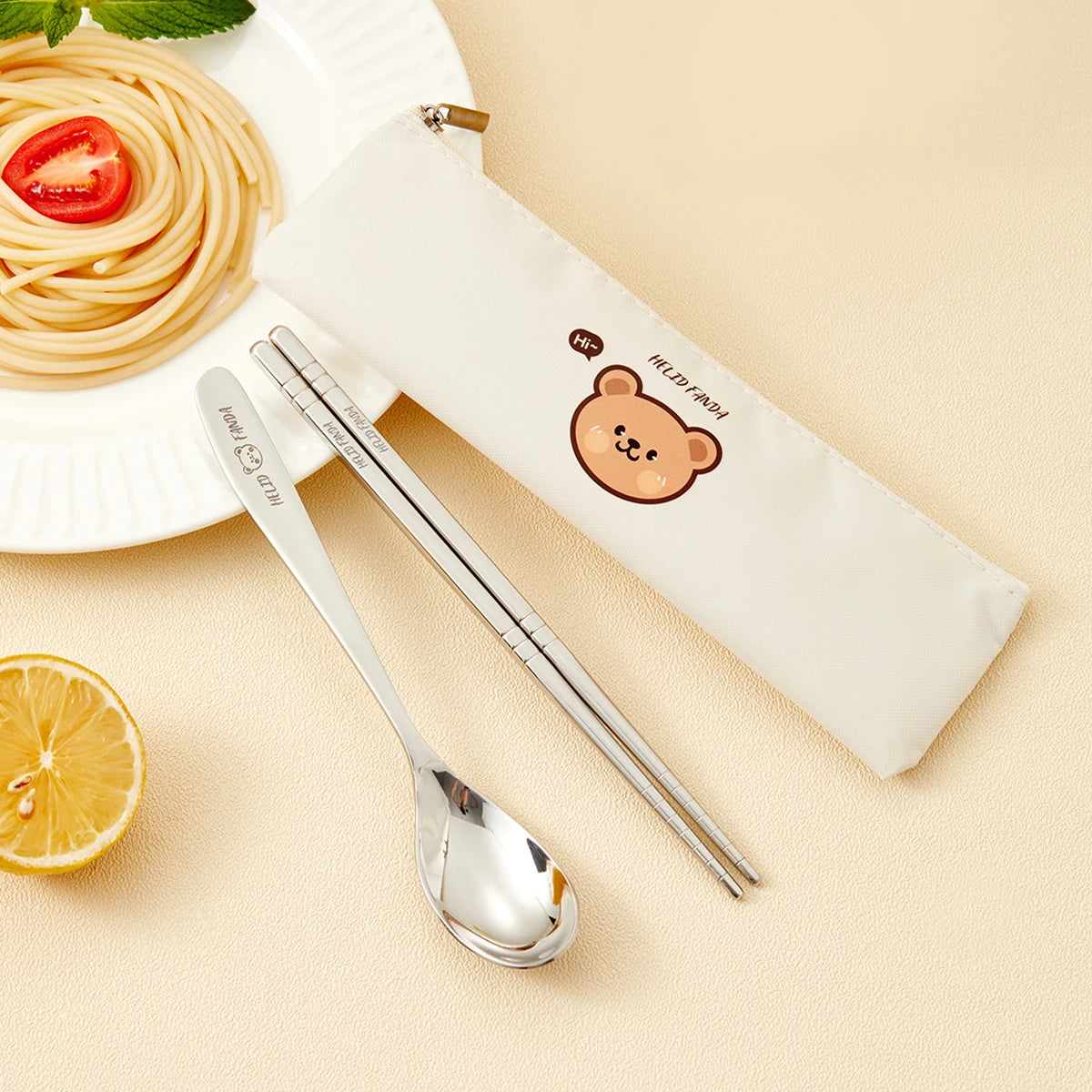 Stainless steel kawaii utensils with a bear-themed case on a beige background