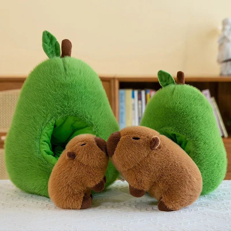 Two kawaii plush beavers and a green pear-shaped house on a light surface with a blurred background.