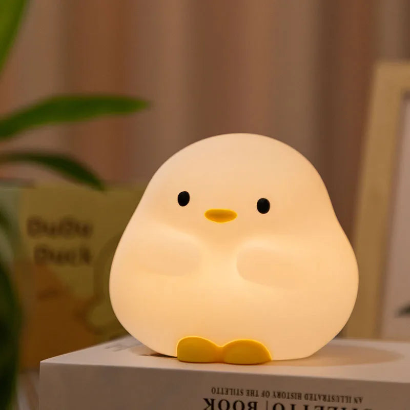 Cute duck-shaped kawaii night light on a surface with a blurred background