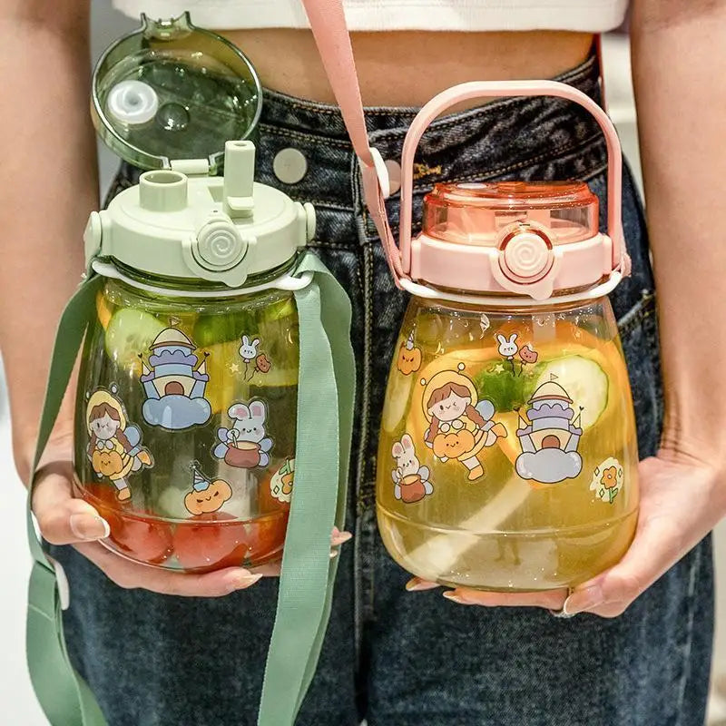 Two colorful kawaii water bottles with cartoon designs held by a person.