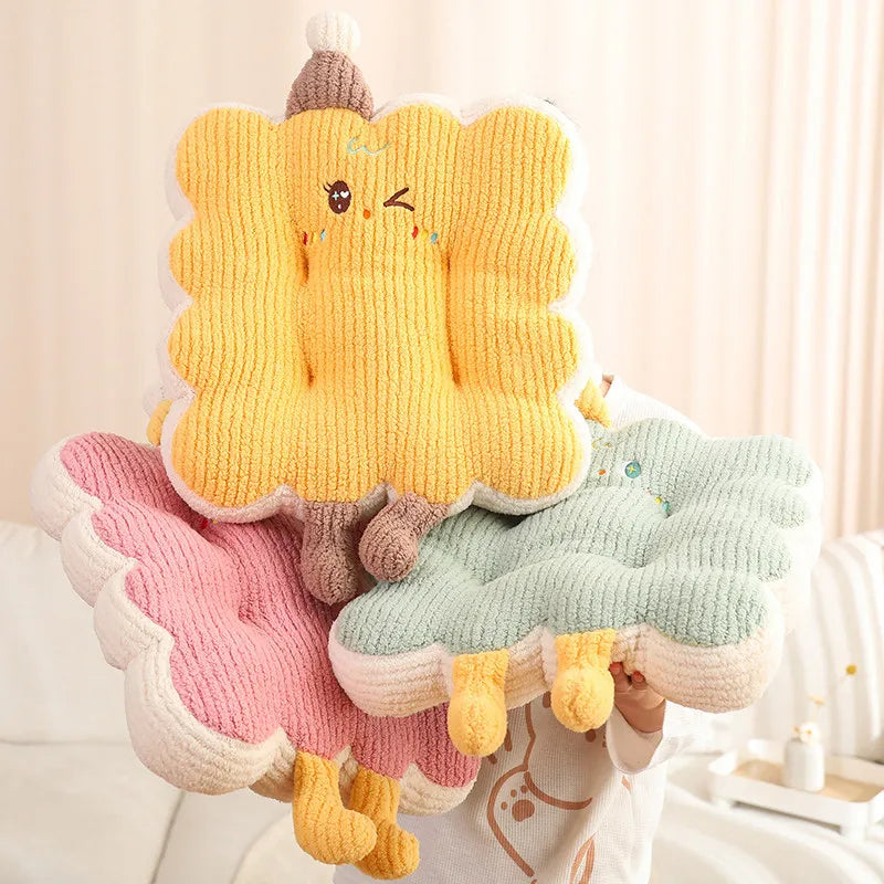 Three colorful knitted kawaii pillows shaped like cartoon characters on a light background