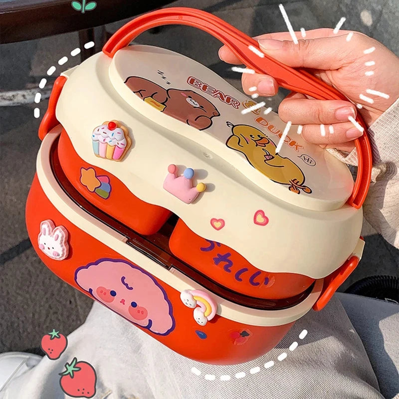 Cute cartoon-themed kawaii lunch box held by a person with colorful designs on a neutral background