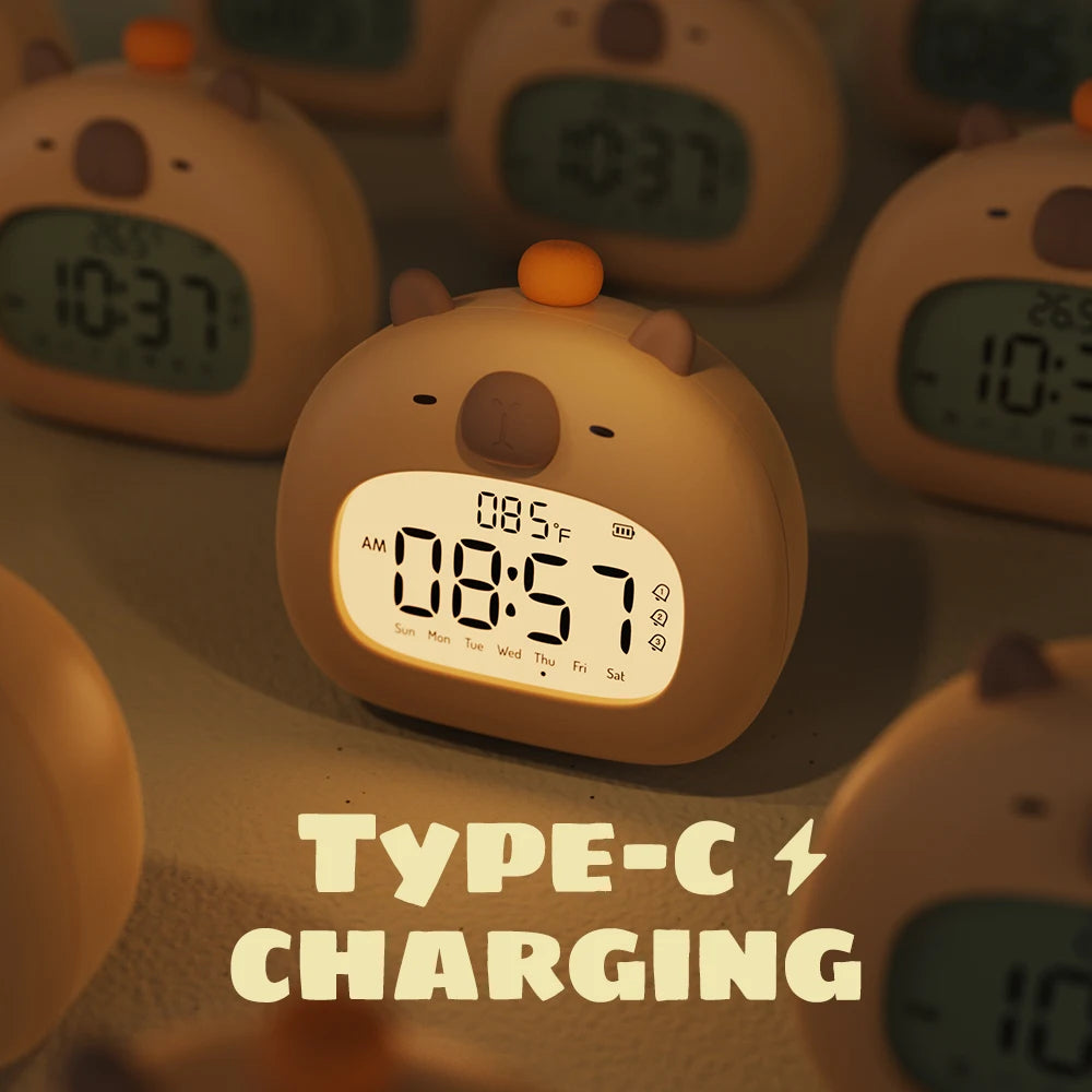 Cute kawaii animal-shaped digital clock with Type-C charging text on a blurred background